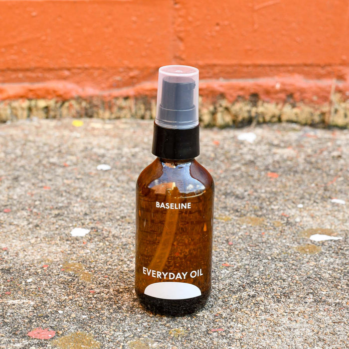 Baseline Everyday Oil made in Asheville, NC in travel size glass amber bottle.