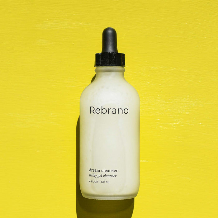 Glass dropper bottle on a milky cleanser from Rebrand.