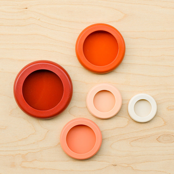 Aerial of all 5 terra-cotta food huggers in a pack.