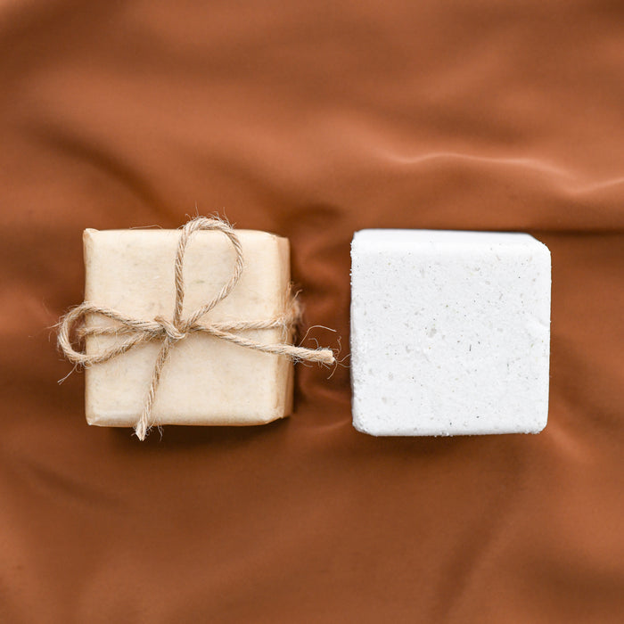 Lavender bath bombs made locally in Asheville, NC. One shown wrapped, one shown unwrapped.