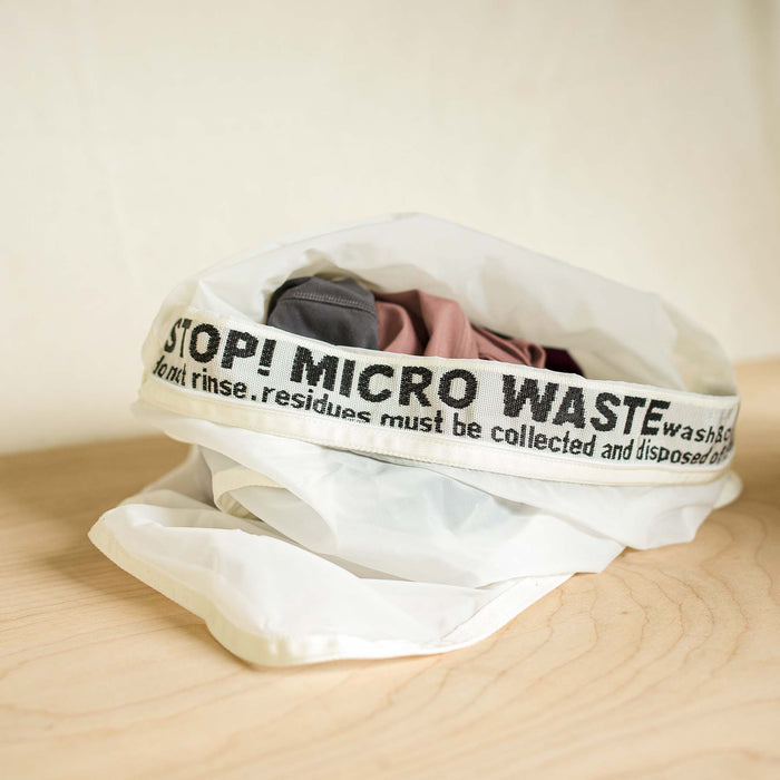 Guppy friend washing bag shown with clothing in bag. Wash synthetics and collect microplastics.