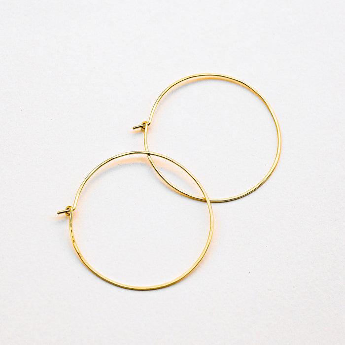 Pair of Gold hoop earrings. Handmade in Asheville, NC.