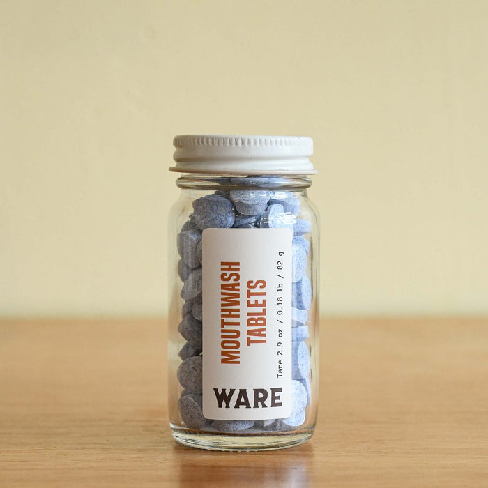 Glass bottle with zero waste mouthwash tablets. By Huppy.