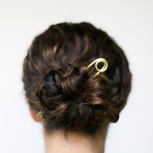 Handmade le loop brass bun pin in hair. 