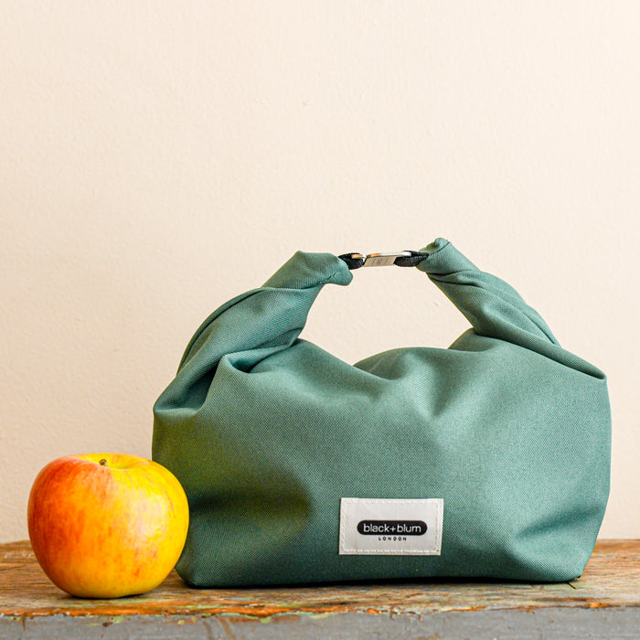 Insulated fold top lunch box. Compare to size of apple. Insulated. From Black and Blum.