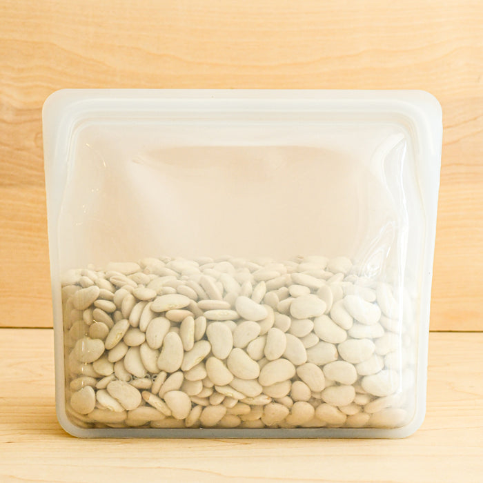 Stasher silicone medical and food grade safe reusable plastic bags. Mega stand up in Clear with beans inside.