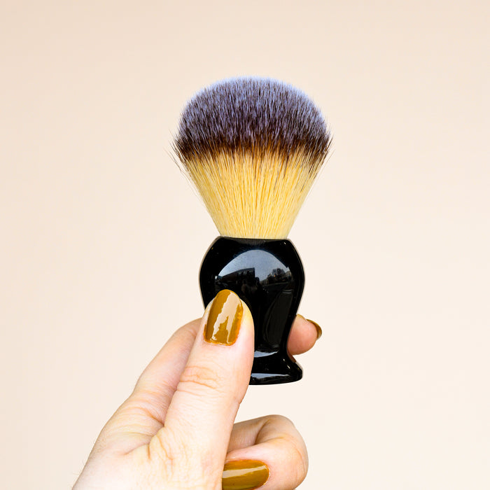 Rockwell shave brush with black self standing base.