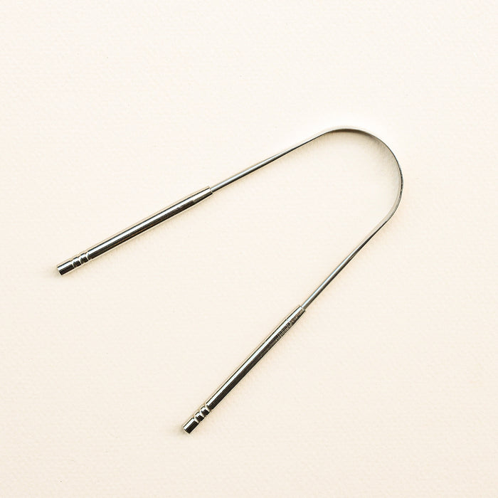 Stainless steel tongue scraper.