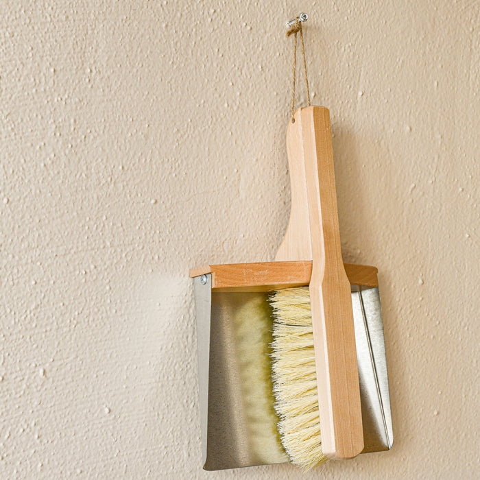 Wood and metal magnetic dust broom with hanging loop.