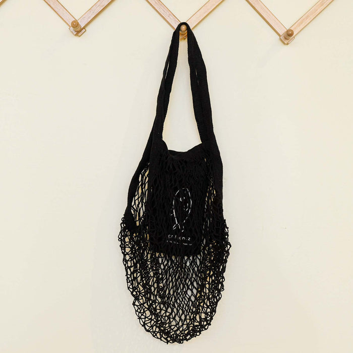 Black ami net market tote hanging. By Graf Lantz.