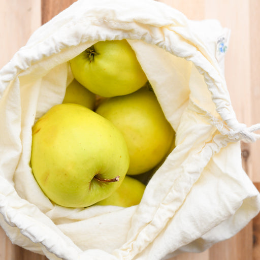 Muslin organic cotton produce bag with apples.