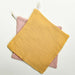 Pink and yellow set of organic cotton muslin washcloths. 