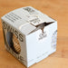 Recycled cotton ball of twine in recycled box with cutter. Cut string on the box.