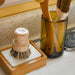 Bamboo soap shelf sitting on kitchen counter with dish block resting in the soap dish. From No Tox Life.