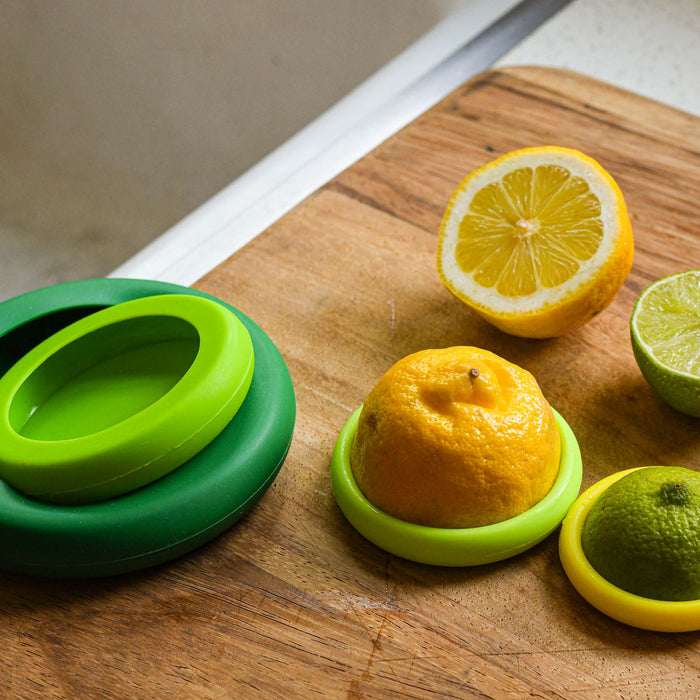Various green sizes of food huggers being used with citrus. 