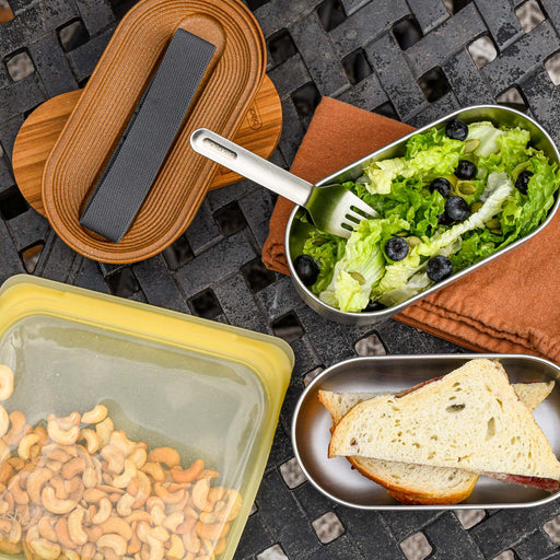 Stainless steel stackable lunchbox on a picnic. From Black and Blum.