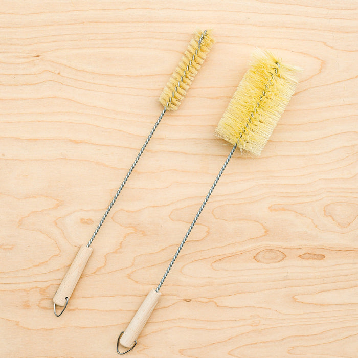 Agave fiber bottle brushes. One narrow, one standard size. Metal stems and hooks at the end.