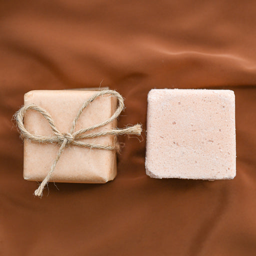 Lavender geranium bath bombs made locally in Asheville, NC.  One shown wrapped, one shown unwrapped.