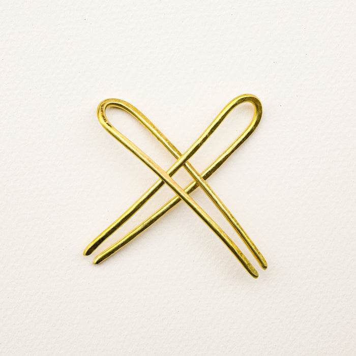 Handmade brass tiny duo bun pins intertwined out of hair. 