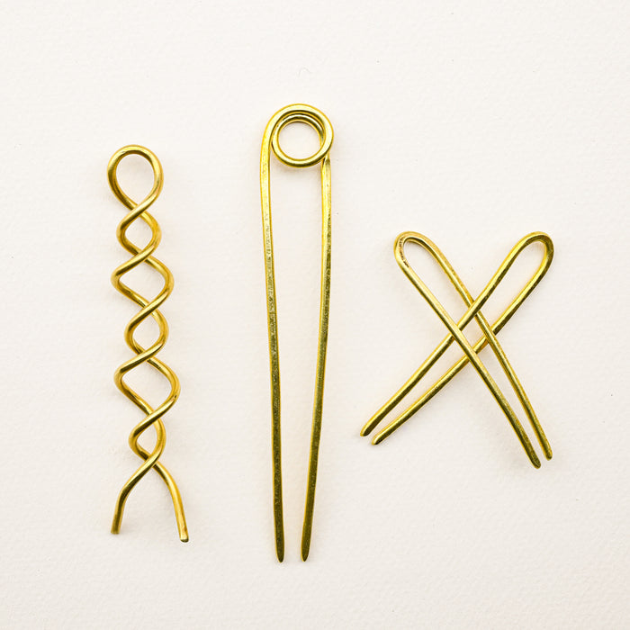 Variety of brass bun pins. 