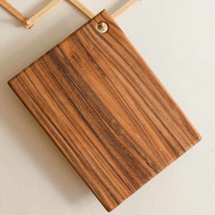 Large rectangular cutting board with a hole for hanging. Made of caro caro wood.