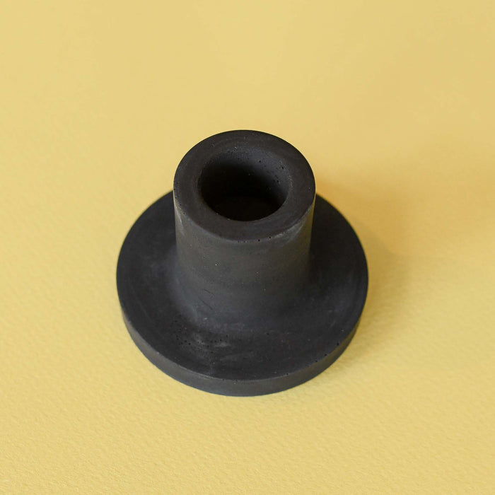 Handmade black colored concrete candlestick holder. 