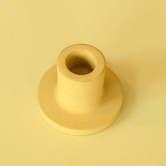 Handmade yellow or chartreuse colored concrete candlestick holder. 