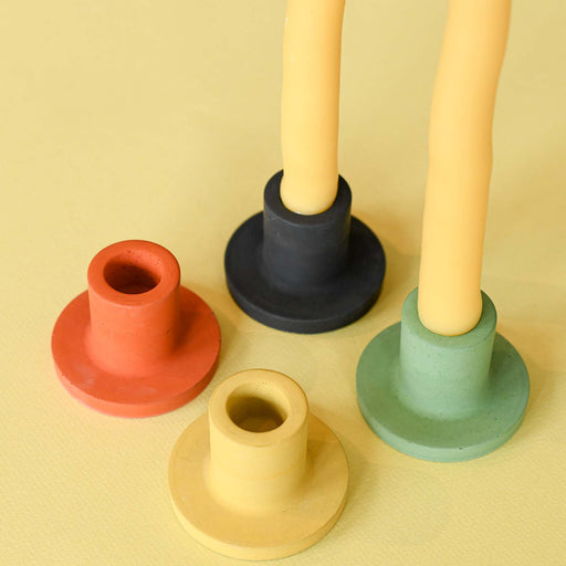 Black, yellow, orange, and green candle stick holders for tapered candles. Handmade.