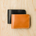 Handmade leather wallets. Bifold one in natural and  one in black.