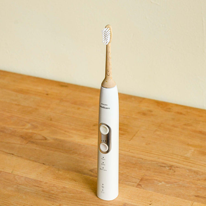 Bamboo electric toothbrush head attached to a Phillips Sonicare toothbrush base.