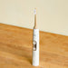 Bamboo electric toothbrush head attached to a Phillips Sonicare toothbrush base.