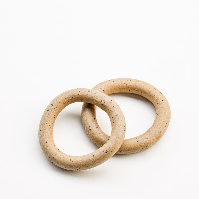 Two circular ceramic napkin rings.
