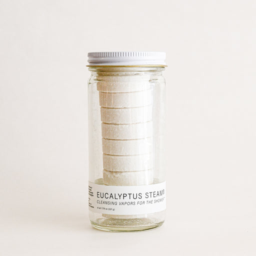 Glass jar filled with nine pucks of eucalyptus shower steams. By No Tox Life.