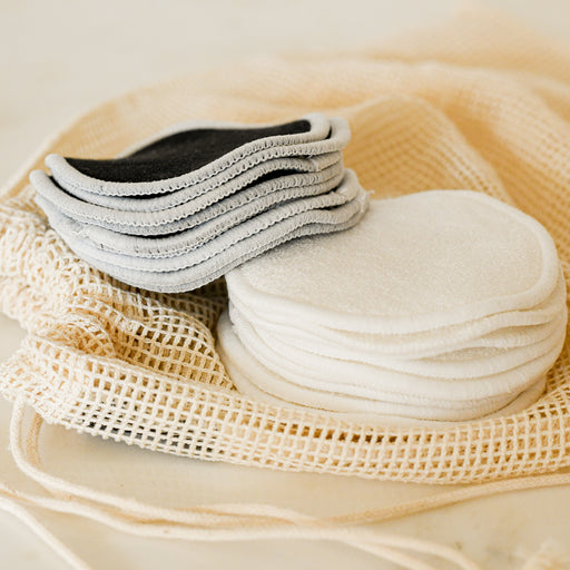 Close up of black and white cotton and bamboo rounds on washing bag. 