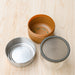 Glass lunch bowl taken apart. Wood fiber base, metal screw on lid. Glass bowl with silicone lid. From Black and Blum.