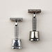 Rockwell razor stands with matching razors in white chrome and gunmetal. 
