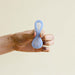 Regular reusable menstrual disc bent for insertion. From Saalt. 