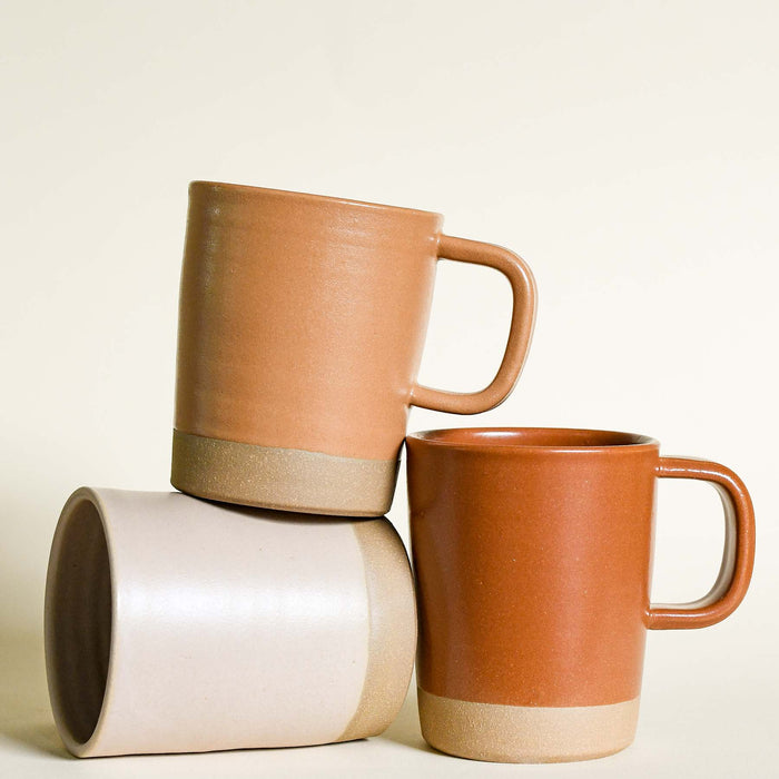 Various ceramic mugs. Three colors with unglazed bottoms.