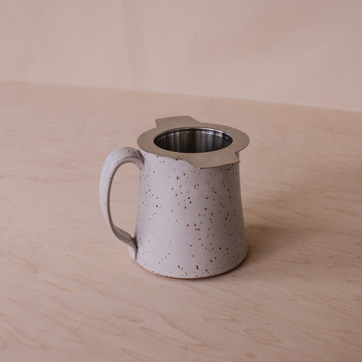 Stainless steel tea infuser strainer in mug.