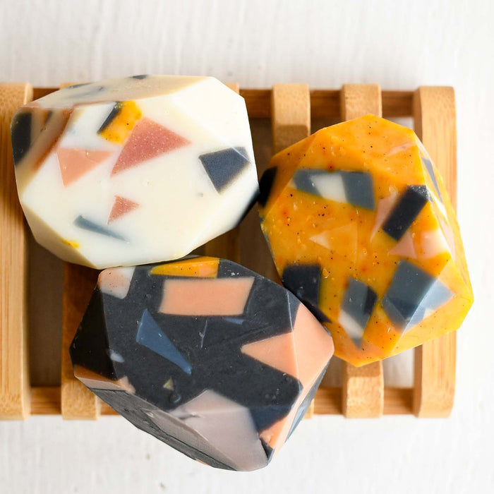 Mini soap scrap soap bars. Gem cut soaps in various colors and scents on bamboo soap tray. 
