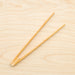 Bamboo toast tongs laying down.