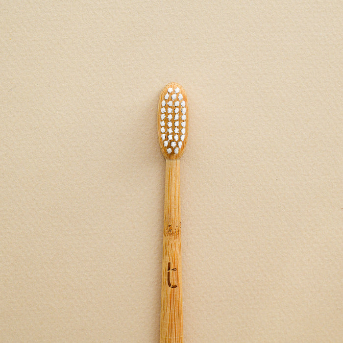 Compostable bamboo toothbrush in medium-firm bristles. From Truthbrush.